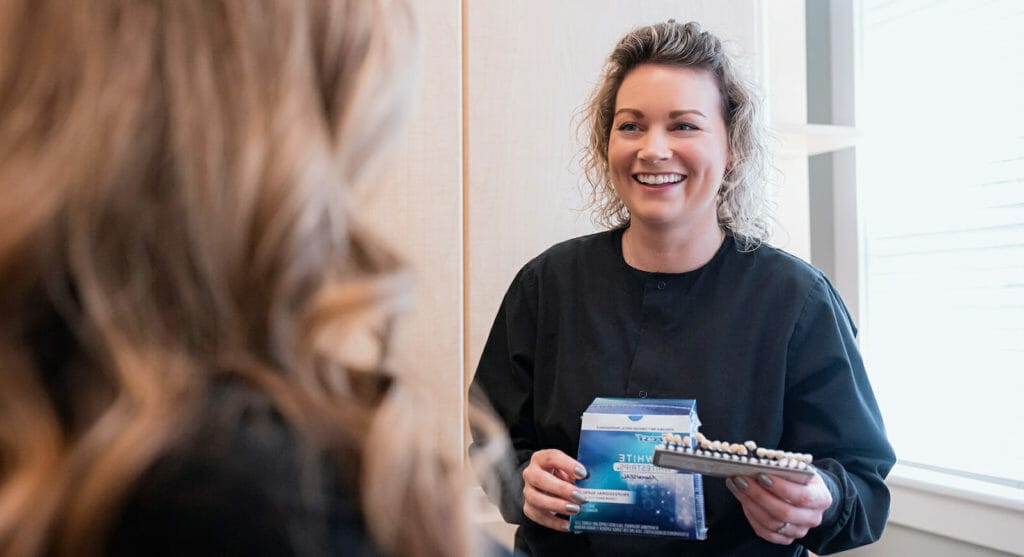 dental hygienist showing patient periodontal maintenance examples