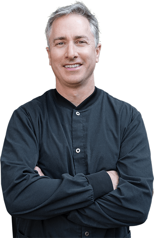 Dr Eric Batterton, DDS in black shirt with arms crossed