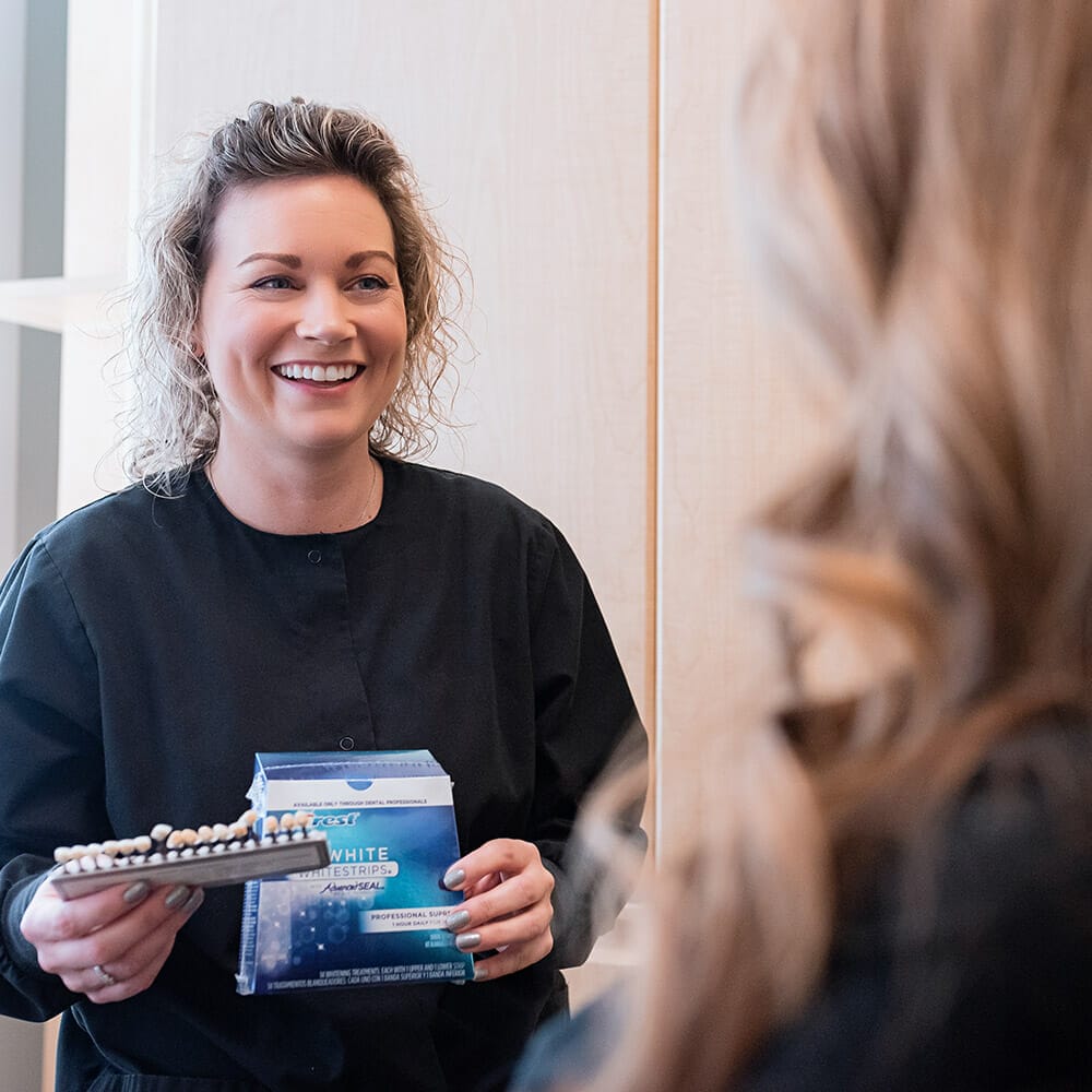 dental hygienist showing patient smile makeover options