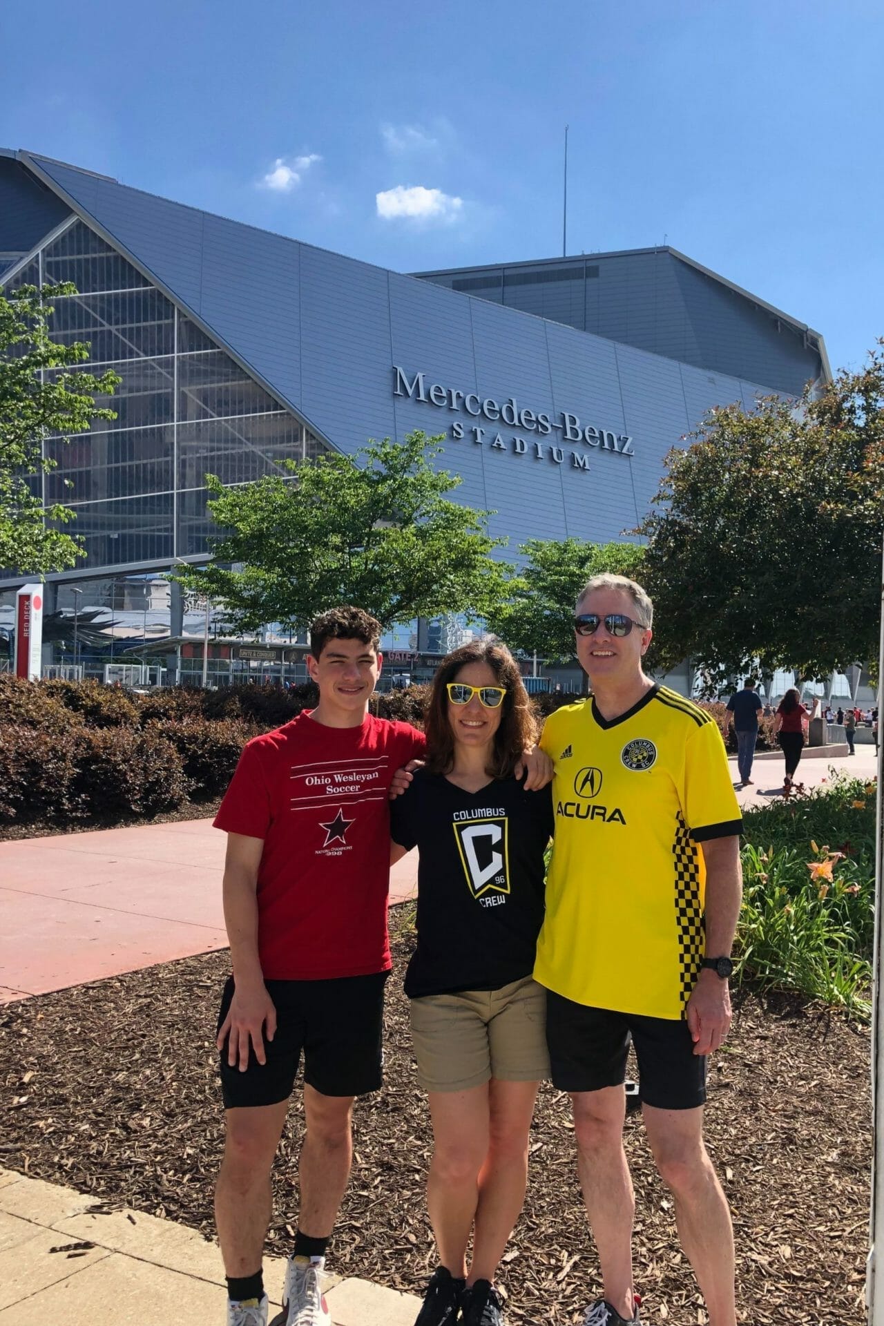 Dr. Eric Batterton and family pose in front of Mercedes-Benz Stadium