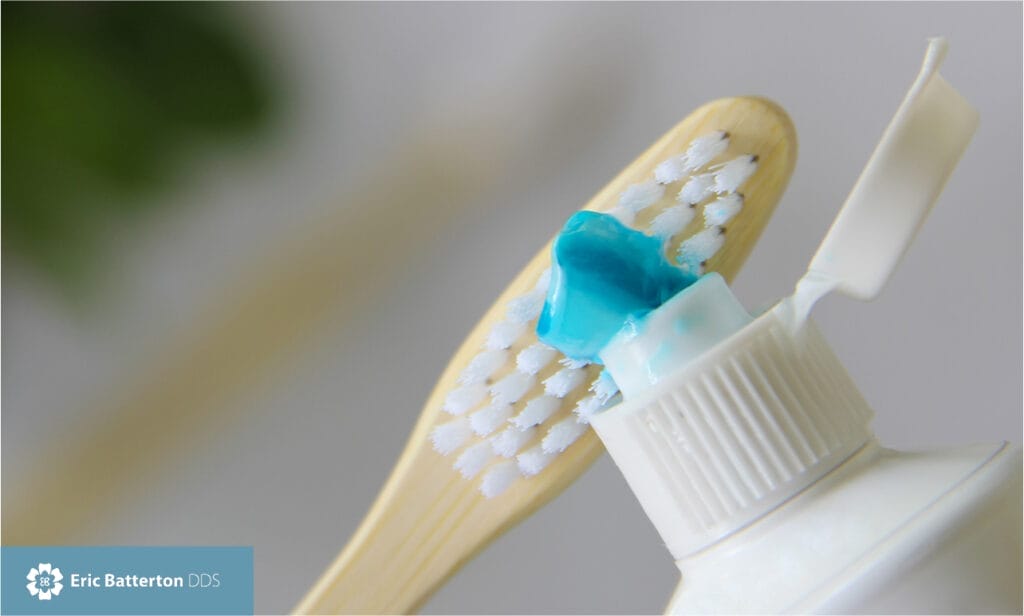 toothpaste being rinse to toothbrush